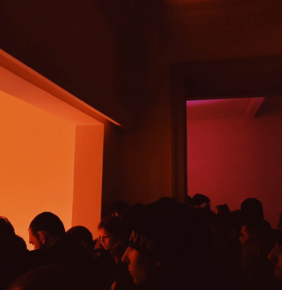 People at an event in orange light