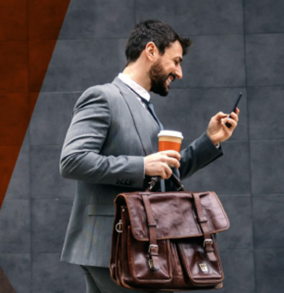 Man in suit with bag checks phone