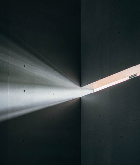 Light protruding through into an empty grey space